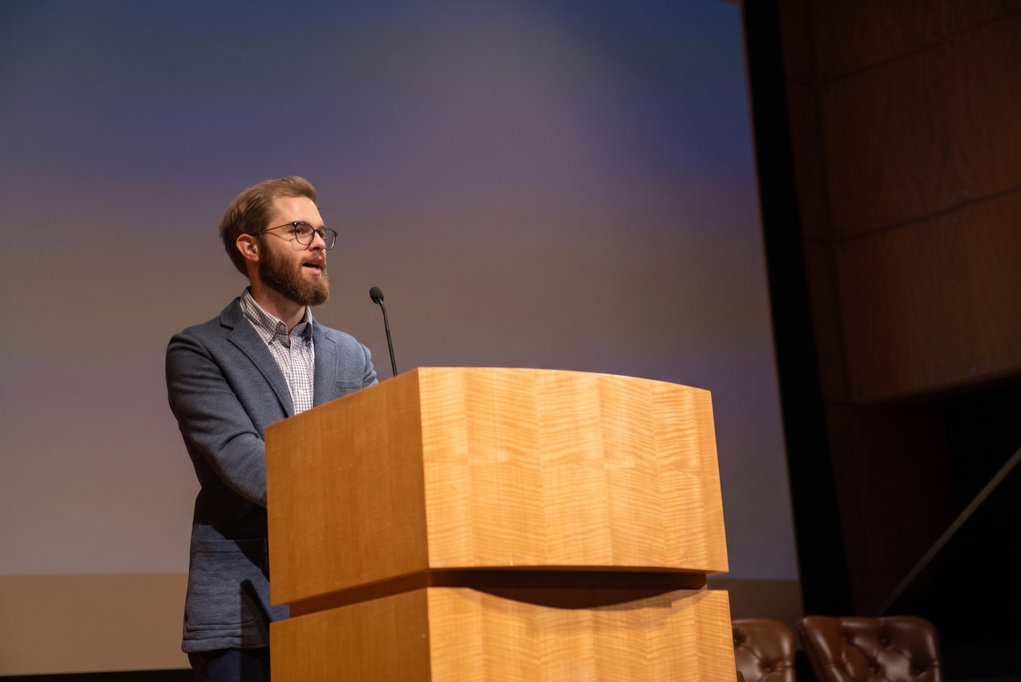 Yoni Neff speaking at a podium